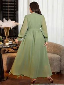 Plus size women's autumn long mock neck lace puff sleeve belted loose dress, green back view