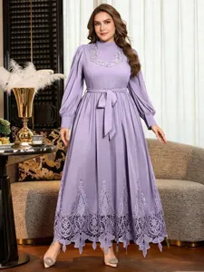 Purple maxi dress detail featuring high neck, bubble sleeves and delicate lace hem.