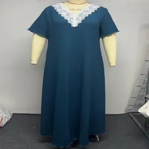 Detail view of the plus size women solid color maxi dress featuring a chic white lace V-neck.