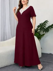 Detail view of the elegant burgundy maxi dress featuring a chic lace V-neckline and short sleeves.