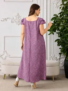 Back view of purple floral maxi dress featuring square neckline and puff sleeves.