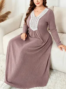 Plus size long sleeve knit maxi dress with elegant white lace V-neck design for women.