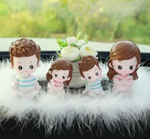 Cute cartoon family dolls detail view, resin car dashboard ornament with decorative feathers.