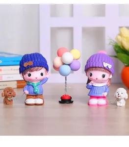 Cute resin couple cartoon figurines set with dogs and balloons for home and room decor.