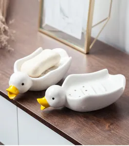 Porte-savon canard en céramique mignon avec trous de drainage pour la décoration de salle de bain.