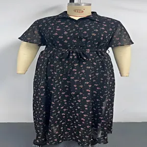 Black floral short sleeve dress detail showing lapel collar and waist tie design features.