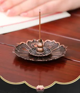 Bronze lotus incense burner holder for stick incense, vintage desktop decor ornament detail.