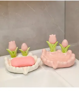 Detail view of ceramic tulip soap dish, cute bathroom sink decor and drain tray.