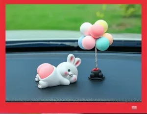 Cute car dashboard ornament cartoon rabbit figurine with colorful balloon tree for interior decor.