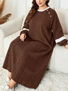 Detailed view of the plus-size cable-knit long dress with contrast cuffs and shoulder buttons.