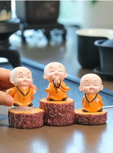 Cute little monk desktop ornament, resin monk figurine with tree stump base for home decor.