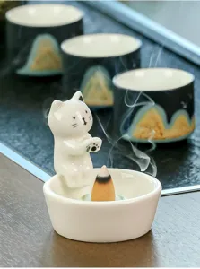 Ceramic cat incense burner detail shot, cute animal aroma diffuser for home office decor.