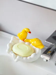 Cute ceramic duck soap dish, charming animal soap holder for stylish bathroom countertop decor.