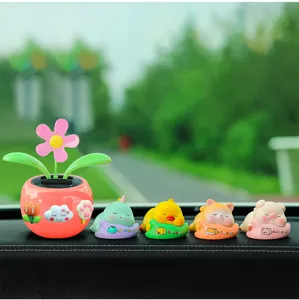 Cute solar shaking flower car dashboard ornament set with sleeping animal figurines.