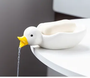 Porte-savon en céramique en forme de canard mignon avec fonction de drainage de l'eau.