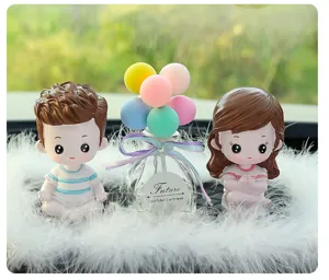 Close-up of cute couple car dashboard ornaments with balloon glass bottle and soft feather base.