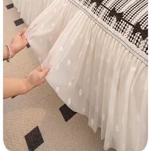 Detailed view of the universal sofa cover featuring black bows and white polka dot sheer mesh layer.