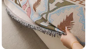 Detail shot of retro chenille sofa cover texture, ethnic geometric pattern with delicate tassels.