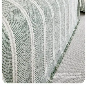 Detailansicht des Retro-Chenille-Sofabezugs mit grünem Strukturstoff und Fransen.