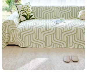 Detailed view of green and white patterned cooling silk sofa cover in a bright living room.