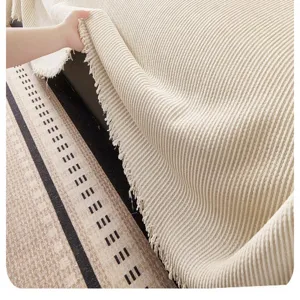 Textured chenille sofa blanket detail showing soft fabric and fringe design for cozy living.