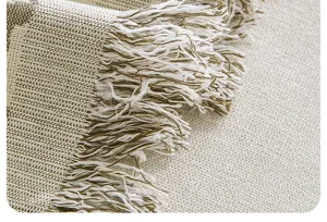 Pastoral style woven sofa cover blanket detail macro shot with elegant fringe design