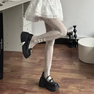 Detail shot of Japanese Lolita white lace tights with cute bows and heart mesh pattern.