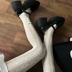 Close-up of white lace heart pattern lolita tights with black chunky shoes detail shot