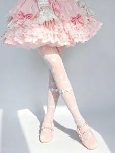 Lolita white pattern over knee stockings, sweet bow cross lace tight socks detail view.