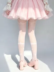 White Lolita over-the-knee stockings with sweet bow and lace details, detail view.
