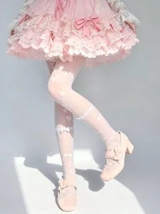 Detail shot of white Lolita over-the-knee stockings with sweet butterfly prints and bows.