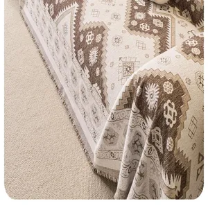 Detailed close-up view of bohemian geometric chenille sofa cover texture and fringe tassels.