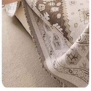 Close-up view of chenille sofa cover fabric texture, retro woven pattern and tassel detail.