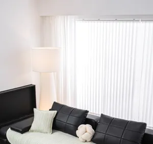 Detail shot of a modern ice silk sofa cover mat in light green with black cushions.