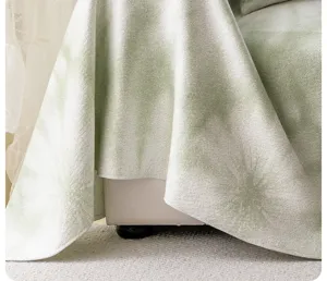 Close-up detail of light green patterned sofa cover showcasing premium draped fabric texture.