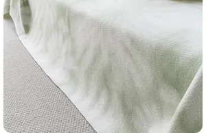 Cooling silk sofa cover detail, soft breathable fabric texture for home living room decor.