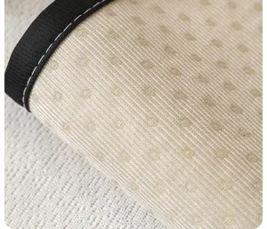 Close-up of anti-slip sofa cushion backing featuring textured fabric and silicone dots.