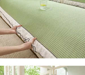 Ice silk waffle sofa cover detail showing delicate lace trim and cool green texture for summer use.