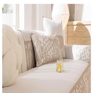 Close-up detail of beige floral ice silk sofa cover, anti-slip fabric for summer living room.