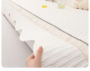 Chenille sofa cushion detail view, close up showing soft textured fabric and elegant edge ruffles.