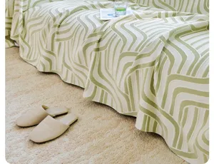 Cooling silk sofa towel detail featuring stylish green geometric wave pattern and soft texture.