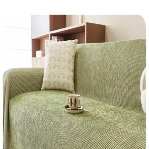 Detailed view of green chenille sofa blanket showcasing thick texture in a cozy room decor scene.