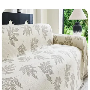 Detailed view of pastoral style leaf print sofa cover throw blanket, cozy home textile decor.