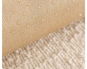 Anti-slip backing detail of sofa cover, mesh fabric with silicone grip dots for stability.