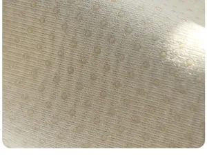 Non-slip sofa cushion fabric detail showing tight weave and dotted grip surface.
