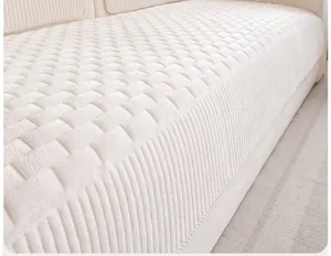 Close-up detail of soft corduroy sofa cushion cover with quilted texture in beige color.