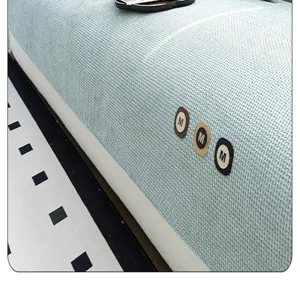 Detail shot of chenille waffle sofa cover showing soft textured fabric and brand patch.