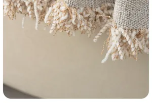Close-up detail shot of textured sofa cover fabric with stylish fringe edge design.