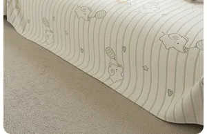 Detailed view of ice silk sofa cover with cute cartoon elephant pattern and green stripes.
