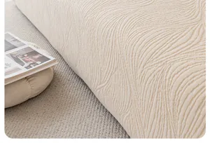Close up view of beige plush jacquard sofa cover detail showing soft textured fabric.